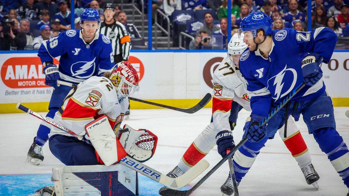 Florida Panthers goaltender Sergei Bobrovsky (72) saves a shot by Tampa Bay Lightning center Brayden Point (21) as Florida Panthers defenseman Niko Mikkola (77) joins the play during the first period in Game 2 of the first round in the Stanley Cup Playoffs Thursday, April 24, 2025 in Tampa.