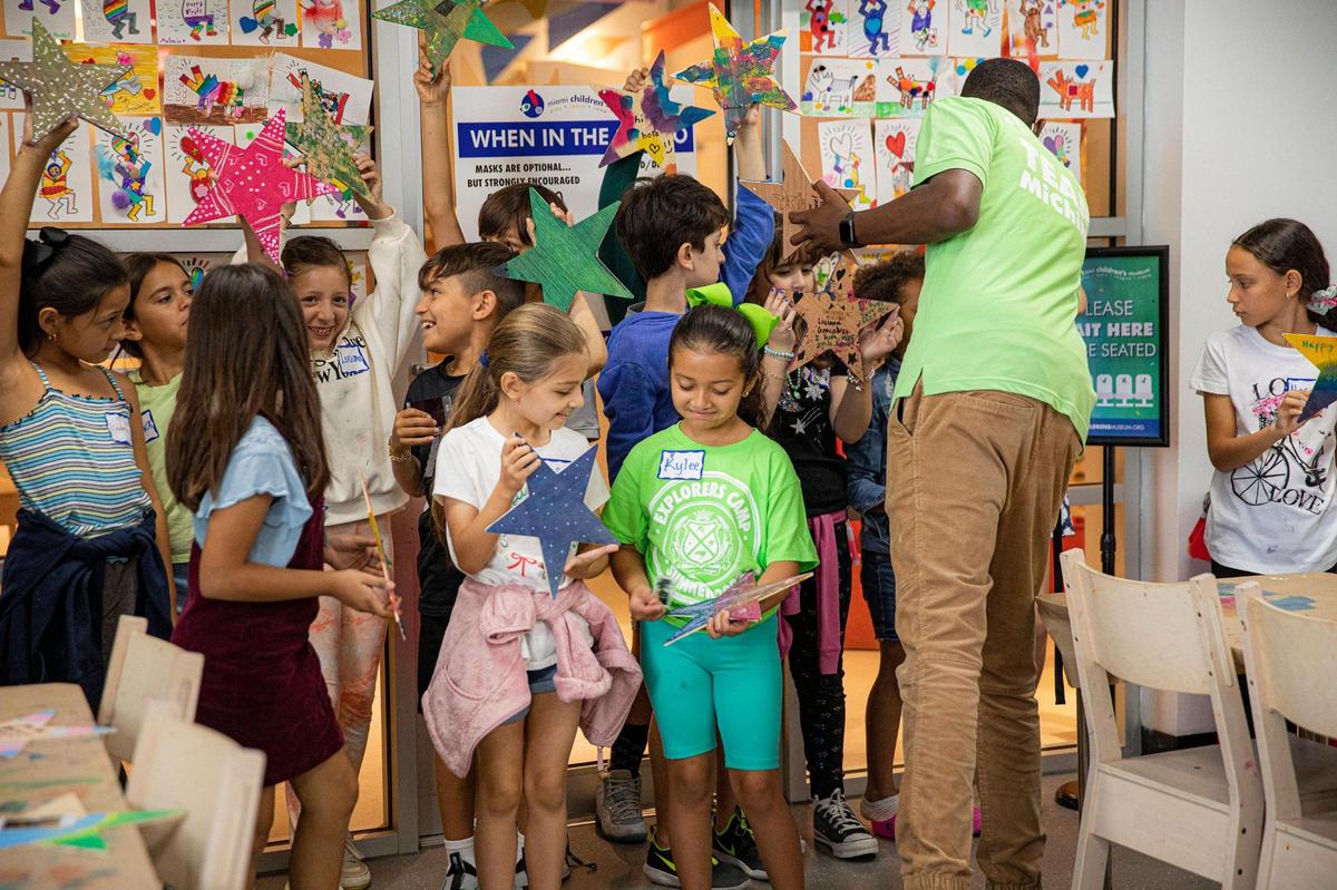 Sofia Gomez, left, and Kylee Vargas, right, show each other the stars they decorated for the Miami Children’s Museum’s Stars of Hope project.