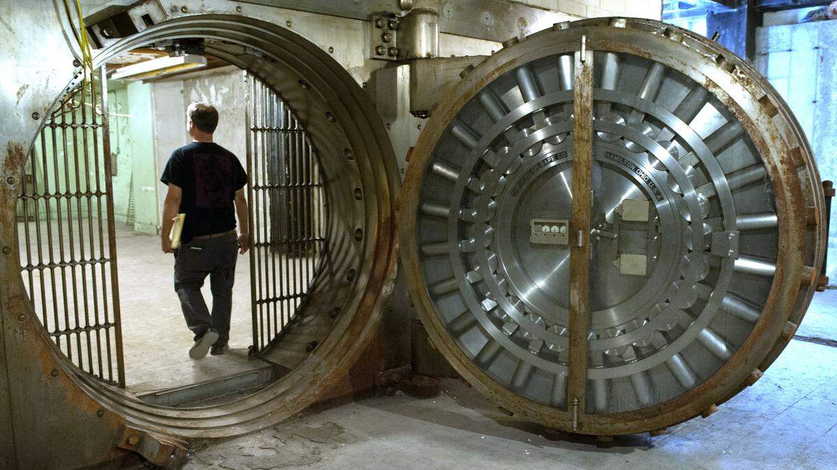 In this photo taken on Aug. 15, 2014, Michael Peoples walks into a bank vault in the basement of The Morton, a 90-year-old hotel building in Grand Rapids, Michigan.