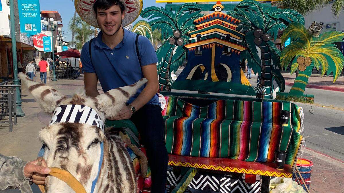 Eon Kounalakis sits astride a zonkey in Tijuana, Mexico.