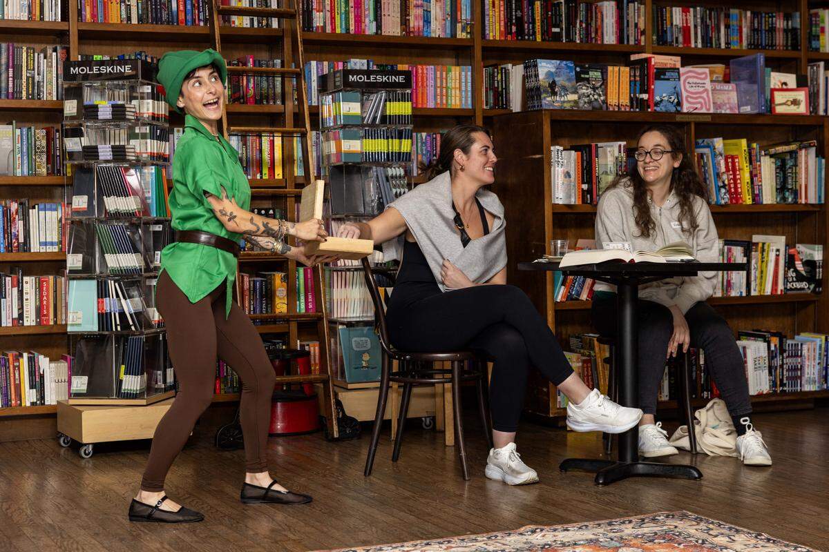 Host Alyssa Expósito conducts a raffle with Meghan Kramer, 32, during The (Silent) Reading Party at Books &Books on Thursday, October 23, 2025, in Coral Gables, Fla.