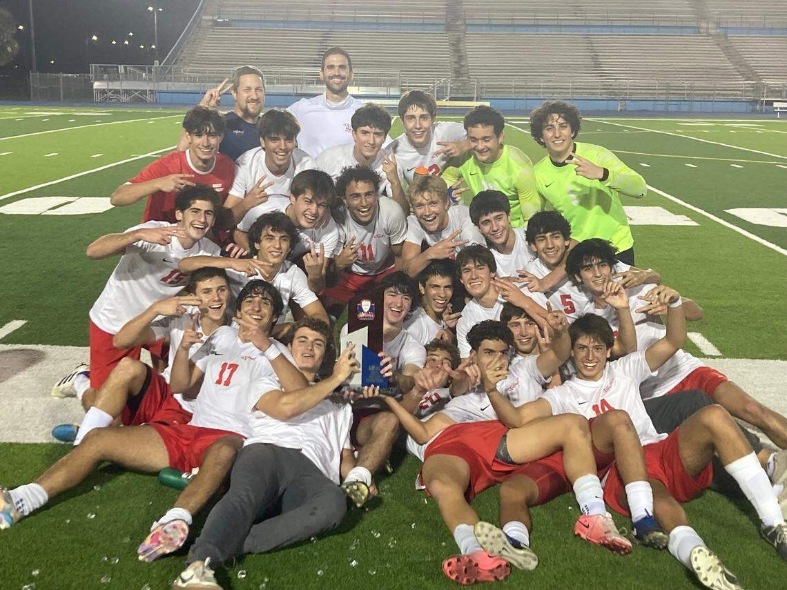 MAST Academy’s boys’ soccer team celebrates after repeating as GMAC champions on Friday night at Traz Powell Stadium.