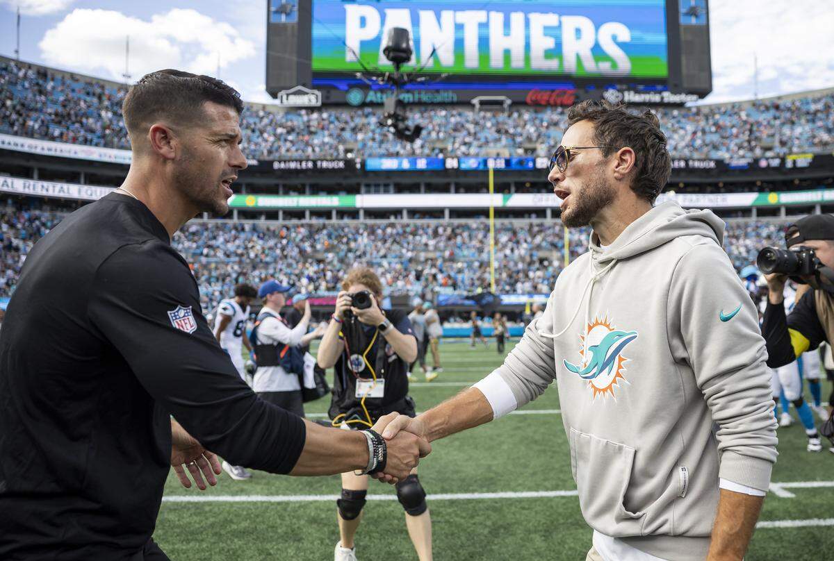 Miami Dolphins head coach Mike McDaniel shakes hand with Carolina Panthers head coach Dave Canales after the Dolphins lost their NFL game at the Bank of America Stadium on Sunday, Oct. 5, 2025, in Charlotte, N.C.