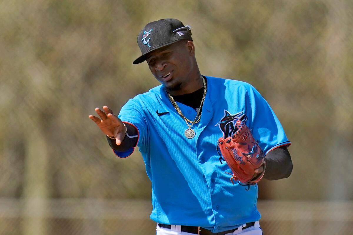 Miami Marlins pitcher Sixto Sanchez gestures while talking to a teammate during spring training baseball practice in Jupiter, Fla., in this Friday, Feb. 26, 2021, file photo. None of the eight pitchers in the mix for the rotation is older than 25.