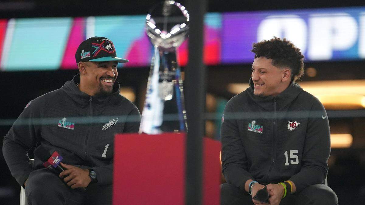 Feb 6, 2023; Phoenix, Arizona, USA; Kansas City Chiefs quarterback Patrick Mahomes and Philadelphia Eagles quarterback Jalen Hurts share the stage during the NFL’s Super Bowl opening night at Footprint Center. Mandatory Credit: Joe Rondone-Arizona Republic