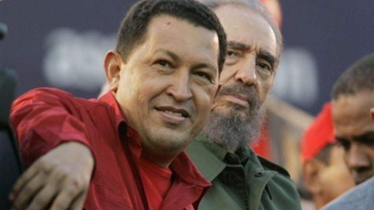 Venezuela’s late President Hugo Chavez, left, sits with Cuba’s President Fidel Castro looks on during a 2006 event in Cordoba, Argentina.