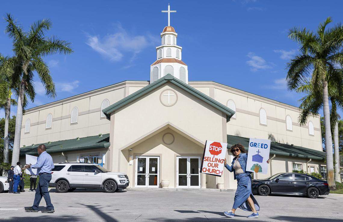 Activists hold signs as they protest outside the House of God Church, Keith Dominion, on Friday, Sept. 19, 2025, in Pompano Beach, Fla. Members of South Florida congregations organized the protest after learning that longtime churches were being sold for what they say is below market value.