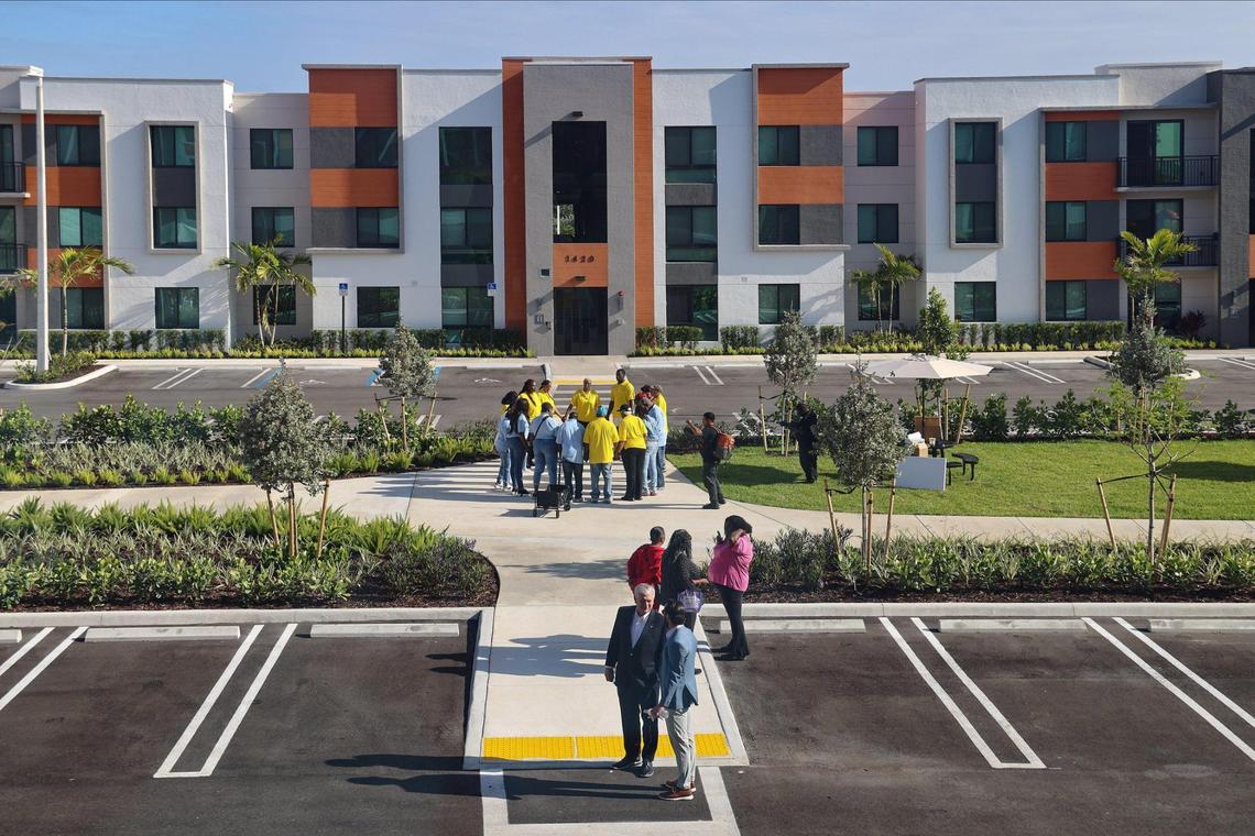 Liberty Square service providers and members of Coalition 305 gather in prayer prior to the start of the ribbon-cutting ceremony at Serenity of Liberty Square, a 193-unit Related Urban housing project.