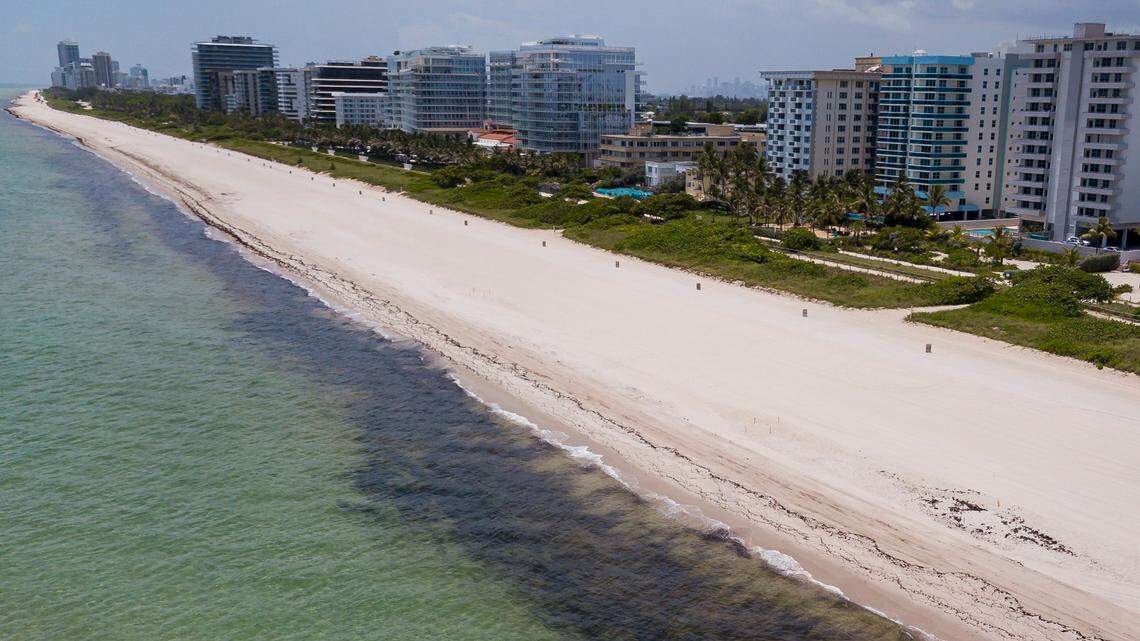 The number of new condo listings dropped by about 53% in Surfside after the collapse. Above: An aerial view of an empty Surfside Beach on Saturday, July 4, 2020.