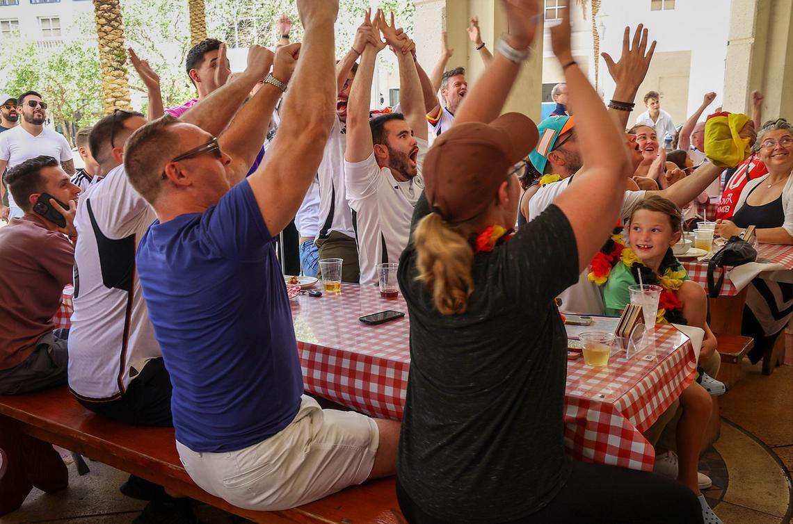 German soccer fans cheer in unison at the packed Fritz & Franz Bierhaus in Coral Gables.