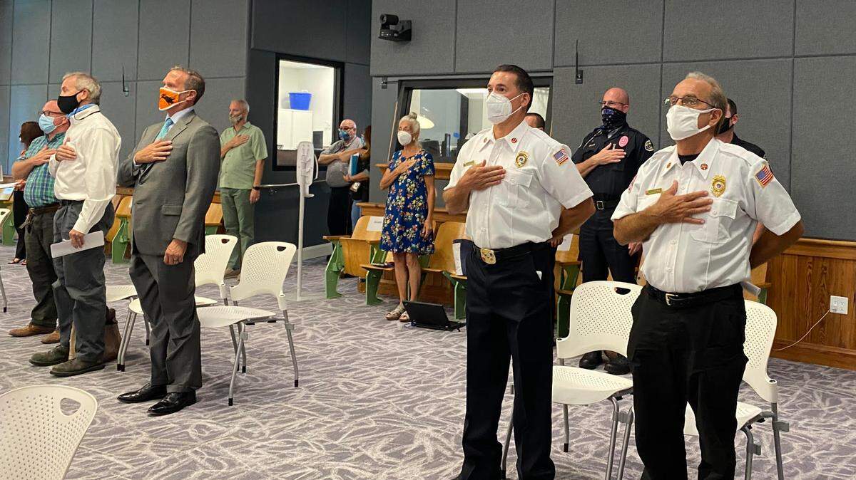 People stand for the Pledge of Allegiance at the Key West City Commission meeting held in person on Oct. 6, 2020, at City Hall for the first time since March.