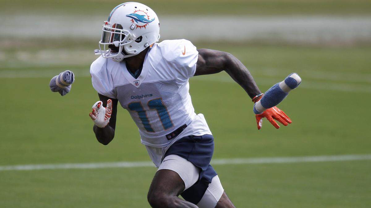 Miami Dolphins wide receiver DeVante Parker speeds through the passing drill during practice at at Nova Southeastern University on Wednesday.
