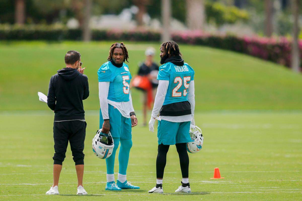 Miami Dolphins cornerback Jalen Ramsey (5) and cornerback Xavien Howard (25) talk to head coach Mike McDaniel during mandatory minicamp at the Baptist Health Training Complex in Miami Gardens, Florida on Wednesday, June 7, 2023. 