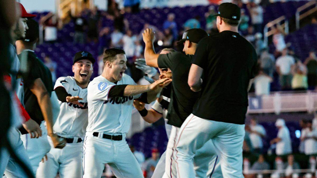 Miami Marlins shortstop Joey Wendle (18) celebrates with teammates on the infield after defeating the St. Louis Cardinals at loanDepot park in Miami on Wednesday, July 5, 2023.