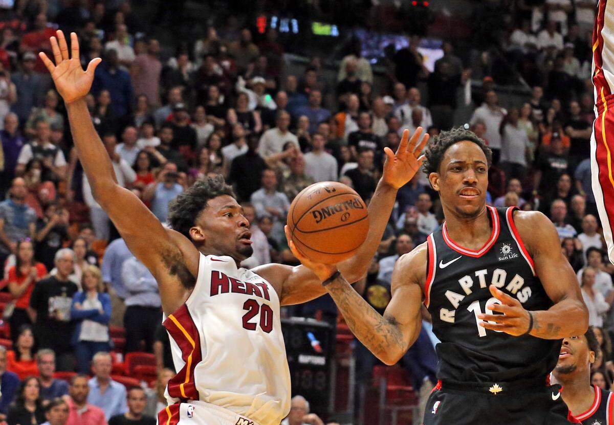 Miami Heat Justise Winslow tries not to foul Toronto Raptors DeMar DeRozan in the fourth quarter at the AmericanAirlines Arena in Miami, Florida, April 11, 2018.