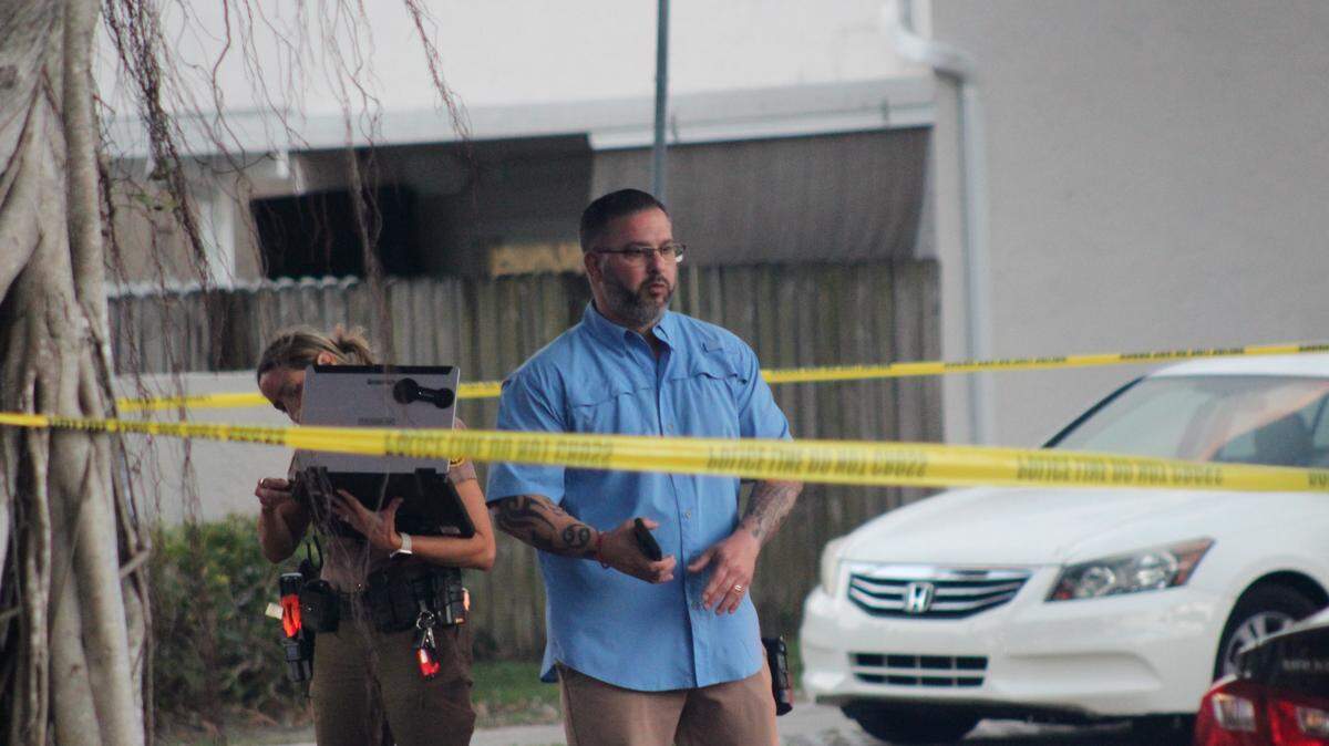A Miami-Dade Sheriff’s Office detective stands behind crime-scene tape in Kendall on Wednesday, Feb. 18, 2026.
