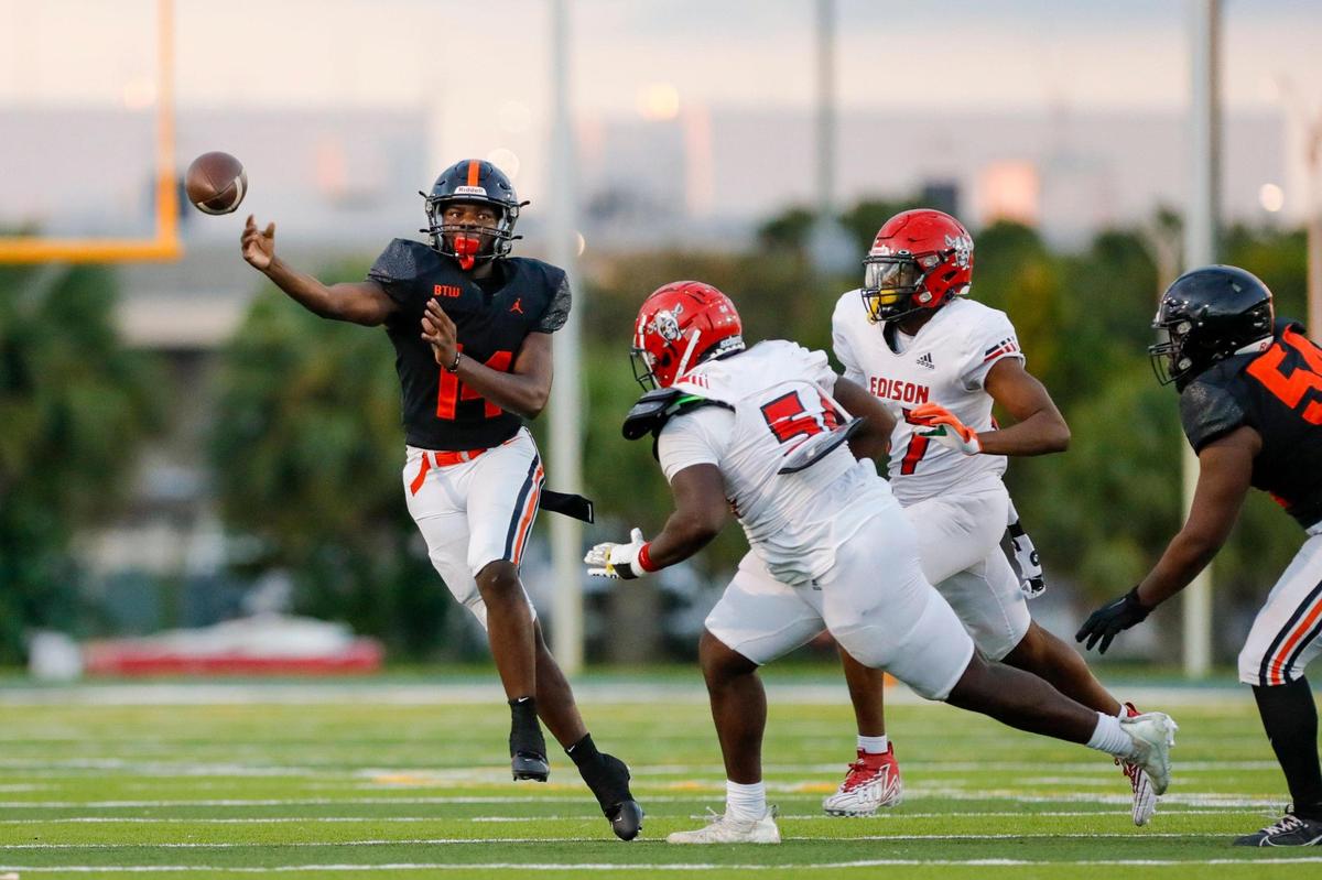 Booker T. Washington quarterback Anthony Mcqueen (14) throws the football against the Edison Red Raiders during the second quarter of a high school football game at Traz Powell Stadium in Miami Florida, Monday, October 16, 2023.