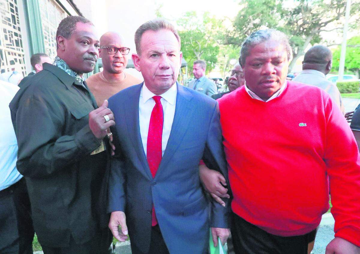 Broward County Sheriff Scott Israel, center, leaves a news conference surrounded by supporters after Gov. Ron DeSantis suspended him over his handling of last February’s mass shooting at Marjory Stoneman Douglas High School.
