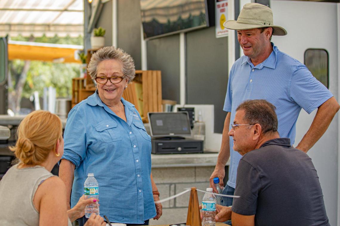 Hostess María Teresa Larios (left) and founder and owner Royd Lemus speak to customers at Royd’s.