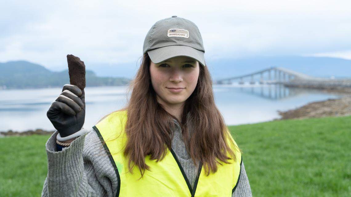 Eline Hauge holding the iron ax fragment.