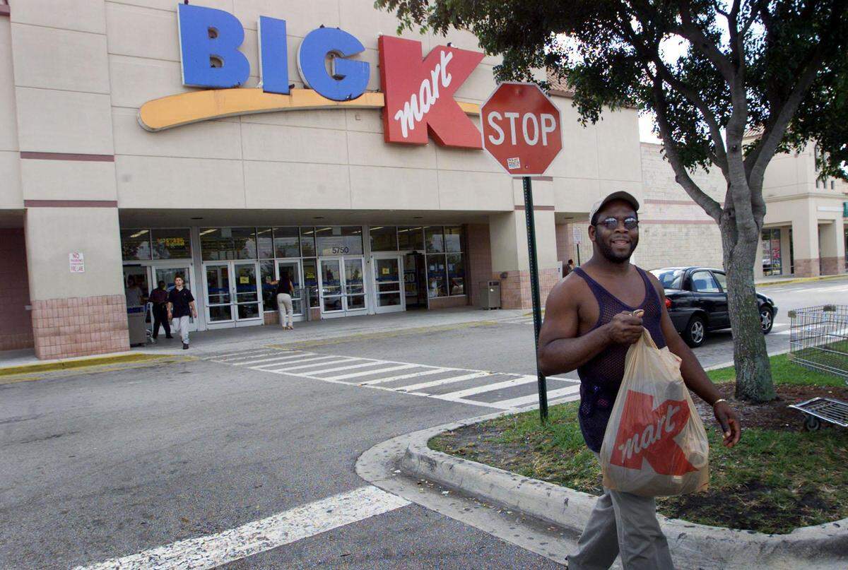 In this file photo from January 2002, customer Gary McDonald leaves Big Kmart on Northwest 57th Avenue and 183rd Street after picking up a few home supplies.