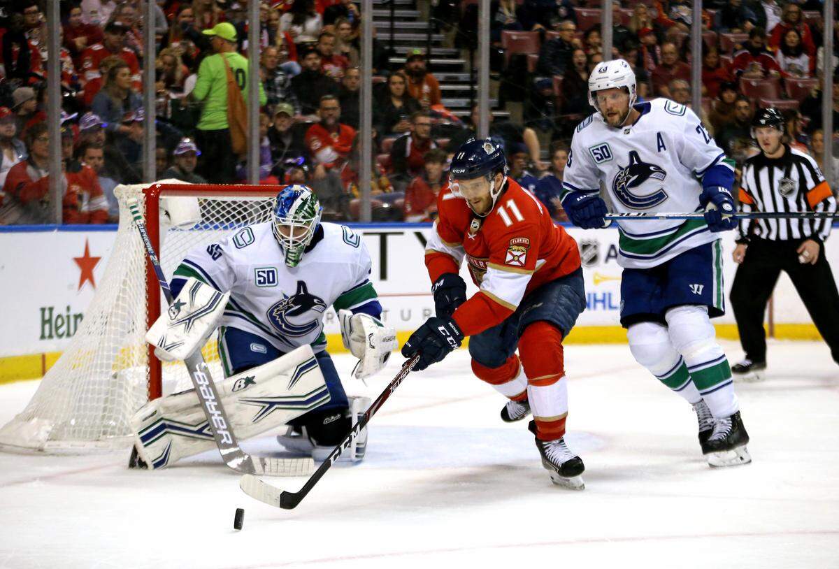 Florida Panthers left wing Jonathan Huberdeau (11) during as chases down the puck as Vancouver Canucks defensemen Alexander Edler (23) defends the goal with Canucks goalie Thatcher Demko (35) the second period&nbsp;of an NHL regular season hockey game at the BB&T Center on Thursday, January 9, 2020 in Sunrise.
