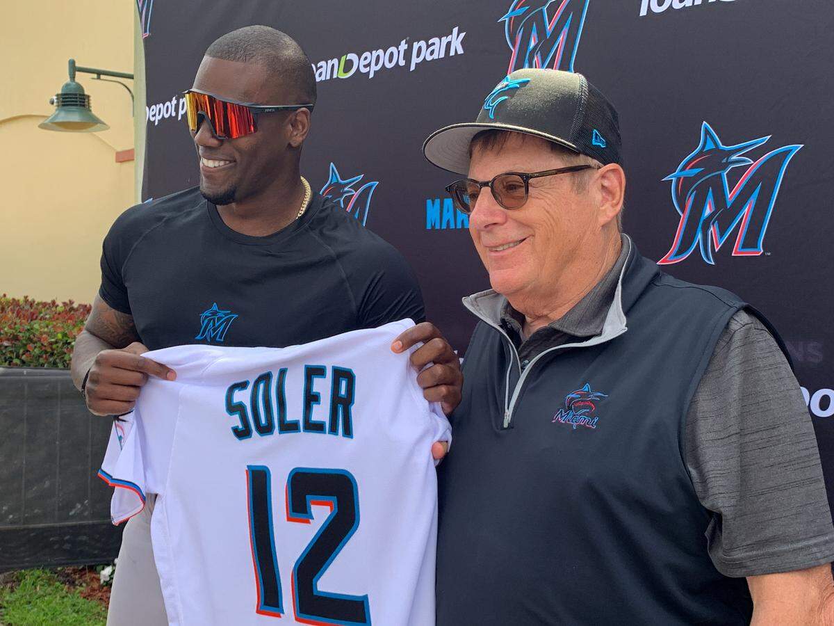 Miami Marlins outfielder/designated hitter Jorge Soler poses with chairman and principal owner Bruce Sherman on Tuesday, March 22, 2022, at Roger Dean Chevrolet Stadium in Jupiter, Florida.