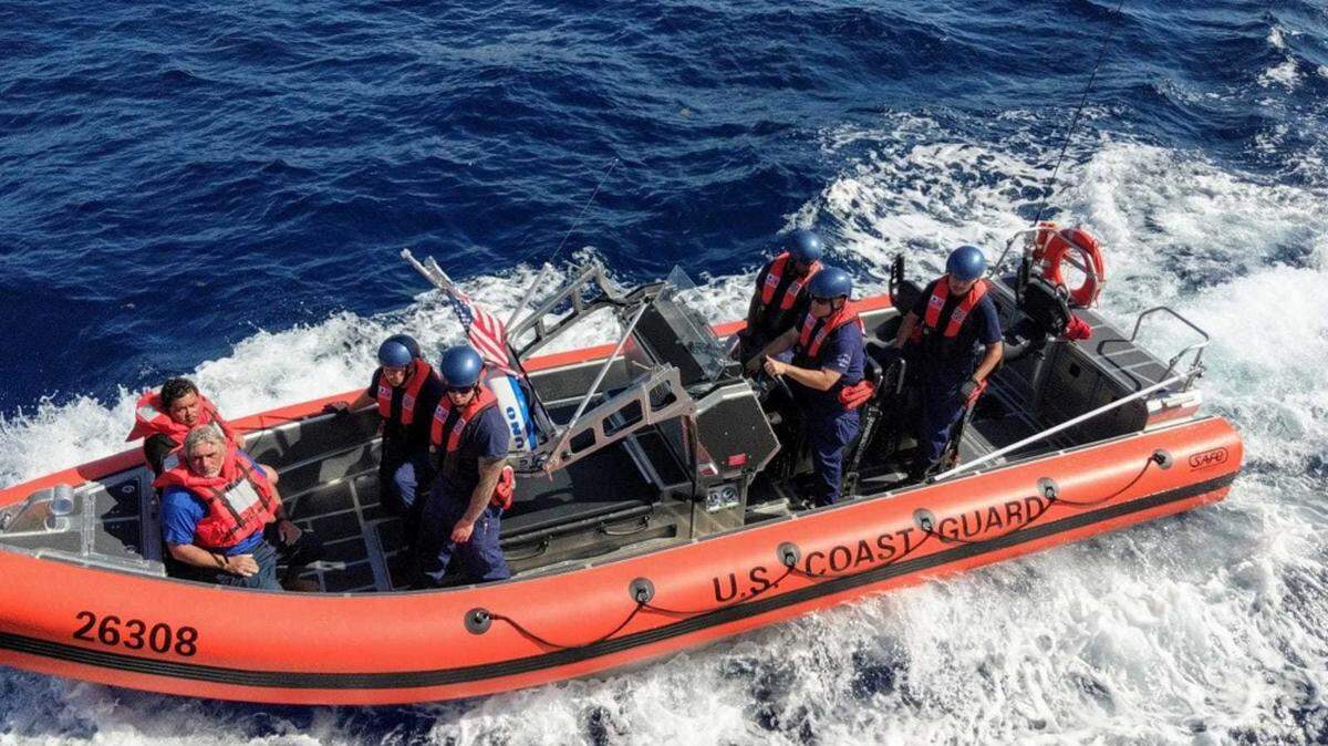 Coast Guard Cutter Terrell Horne (WPC-1131) crew members transport two Mexican men after rescuing them from the water Tuesday, Nov. 20, 2018.