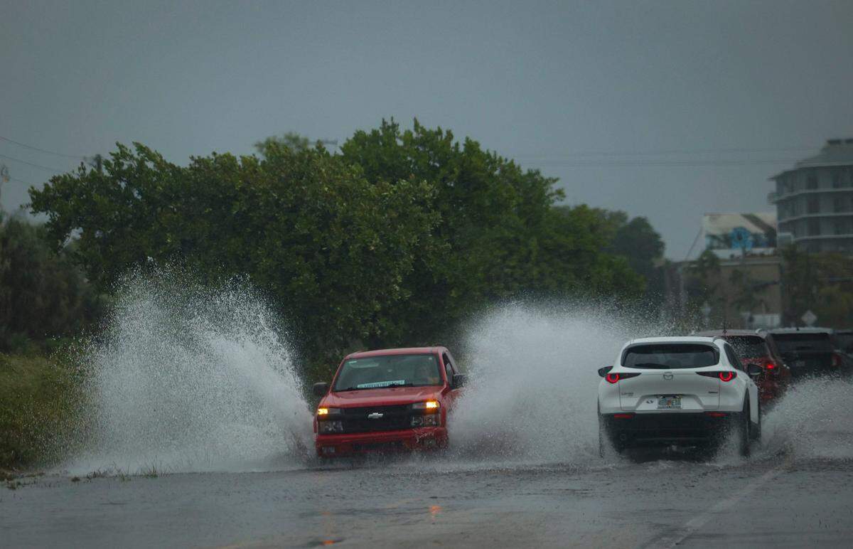 A truck drives through flooding in Little Haiti during a rain storm on Wednesday, April 12, 2023, in Miami.