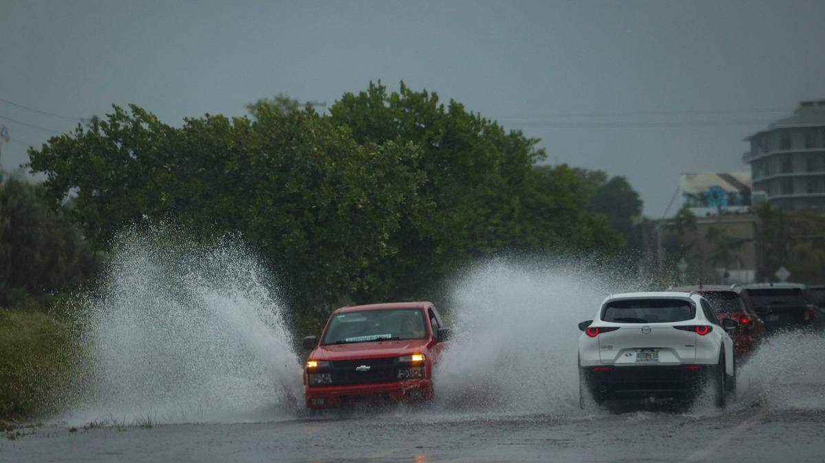 A truck drives through flooding in Little Haiti during a rain storm on Wednesday, April 12, 2023, in Miami.