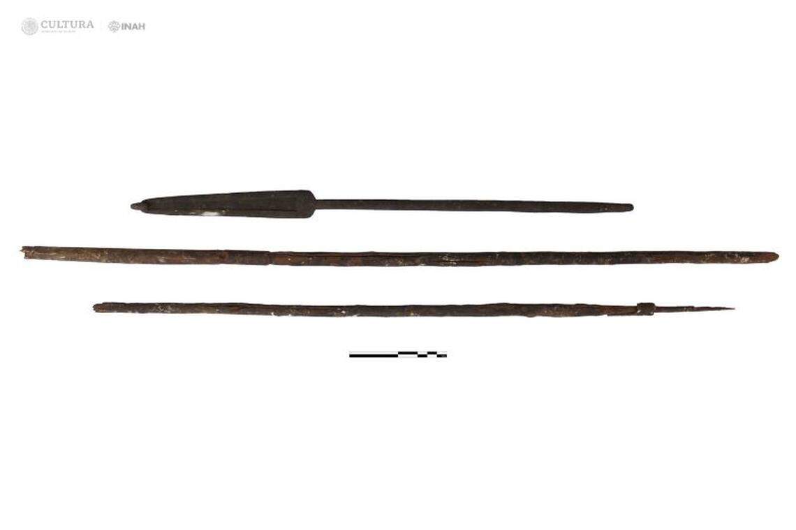 The dart thrower with the two wooden darts recovered from the cave.