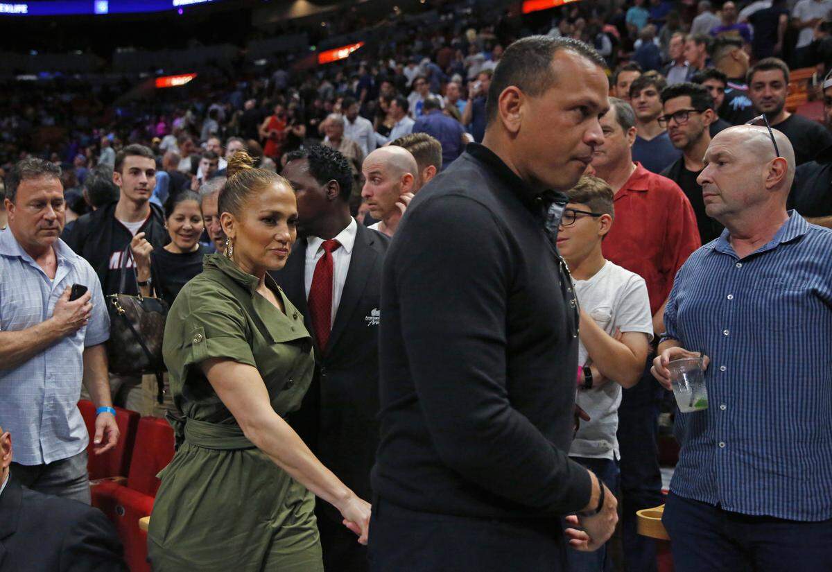 Jennifer Lopez and Alex Rodriguez walk in the second quarter of an NBA basketball regular season game between Los Angeles Lakers against the Miami Heat at the AmericanAirlines Arena on Friday, December 13, 2019 in Miami.