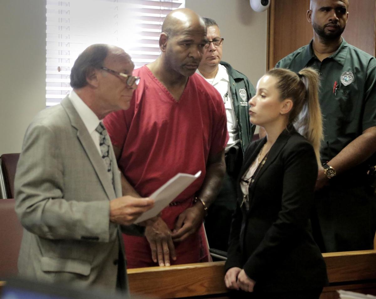 Ariel Gandulla, center, with his defense attorney, left, listens to the judge as the court interpreter translates in Miami-Dade Criminal Court on September 27. Gandulla pleaded guilty to kidnapping charges.