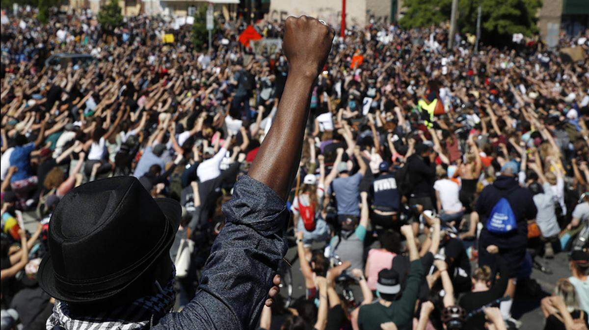 Demonstrators gather in Minneapolis following the death of George Floyd, a black man who was killed in police custody.