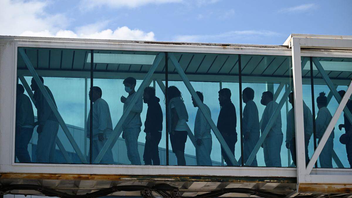 Venezuelan migrants deported from the United States walk upon arrival at Simon Bolivar International Airport in Maiquetia, Venezuela, on January 16, 2026. A new flight carrying 231 Venezuelans deported by the United States arrived on January 16 at the airport serving Caracas, the first since the military incursion that overthrew and captured President Nicolas Maduro. 