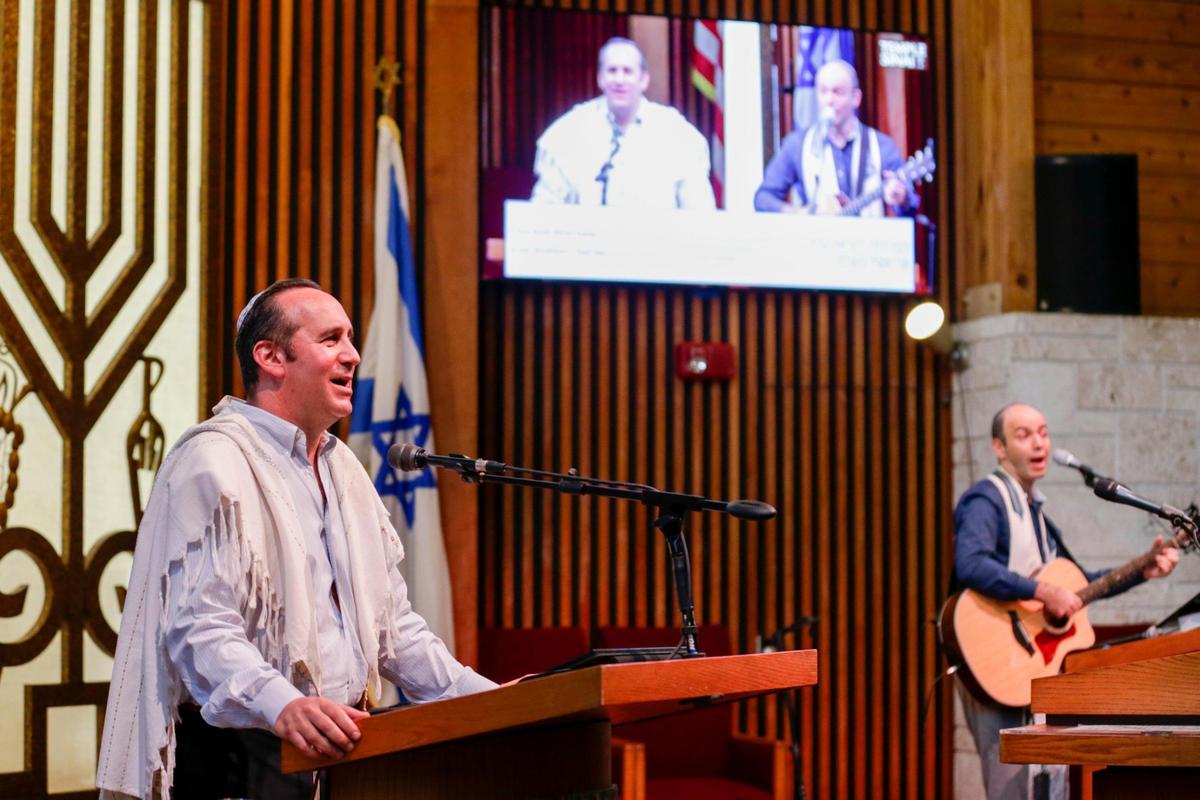 In this file photo, Rabbi Alan Litwak, left, and cantor Norman Cohen-Falah sing inside an empty synagogue Aug. 27, 2021, during an online service for worshipers to stream live from home as the Temple Sinai of North Dade prepares for the Jewish High Holidays services in times of COVID-19.