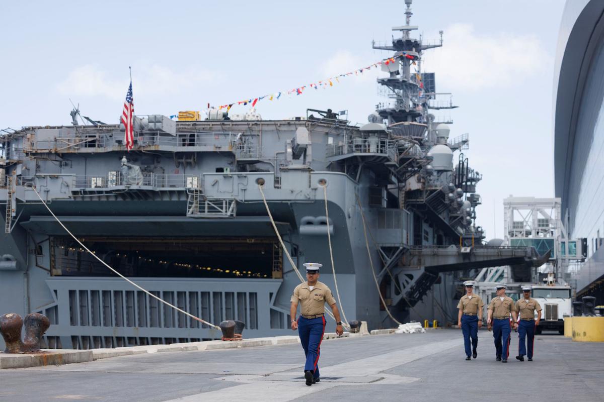 Membres of the United States Marine Corps walk in front of the USS Bataan during the opening day of Fleet Week on Monday, May 6, 2024, at Norwegian Cruise Lines Terminal in PortMiami.