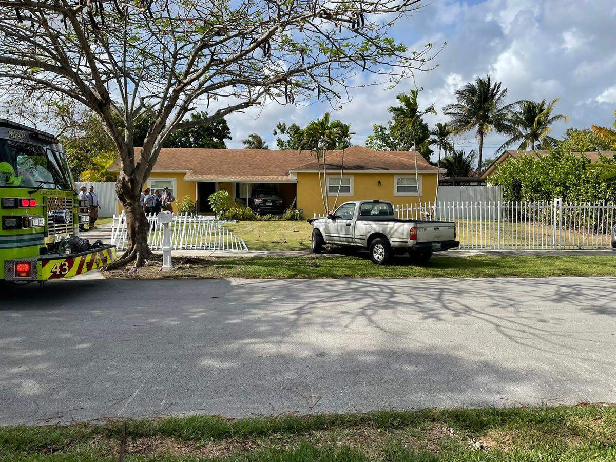 After a car drove into a Miami-Dade County home, a child and the driver were sent to the hospital. The driver was initially trapped inside the car.
