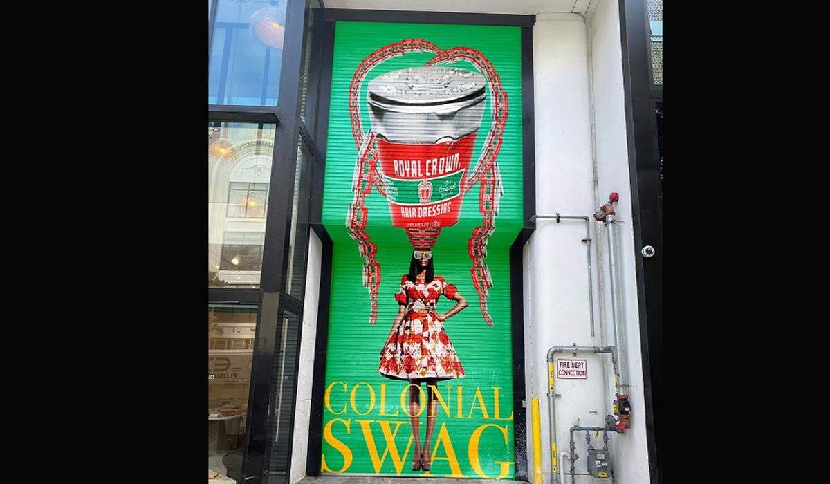 On a rolling garage door in the middle of the Miami Design District is April Bey’s ‘Colonial Day Sale: What Are You Gonna Do, If You Like a Woman and Your Mama No Like Am?’