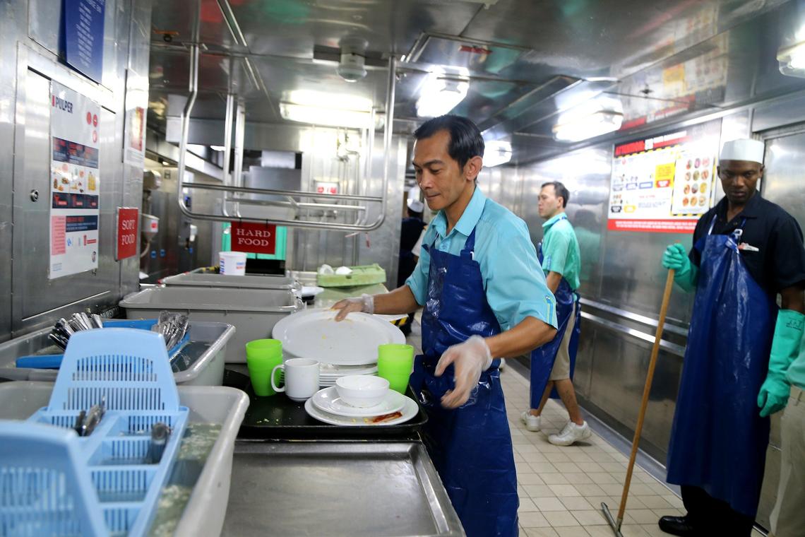 Tanakas, a waiter, separates food waste and recyclable materials on Friday, October 11, 2019 aboard the Carnival Cruise Line ship Carnival Victory.