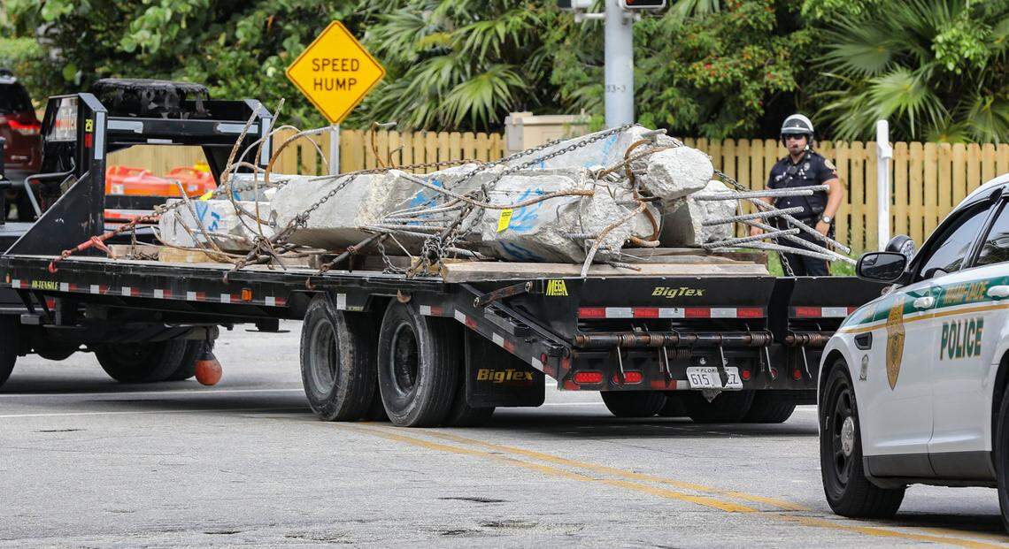 Large sections of concrete are transported from the debris field of the 12-story oceanfront condo, Champlain Towers South in Surfside on Wednesday, July 7, 2021.