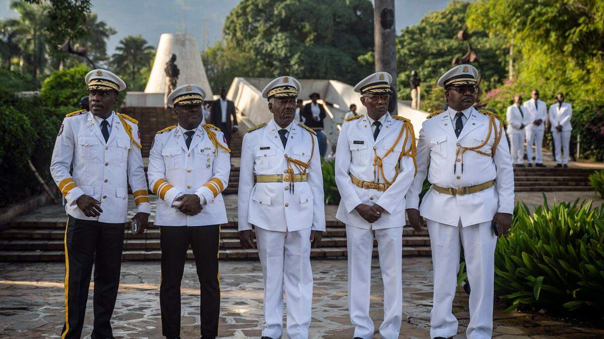 Haitian Police Chief Frantz Elbe, second from left, waits with officers for Prime Minister Ariel Henry before a ceremony marking the death anniversary of revolutionary leader Jean-Jacques Dessalines at the National Pantheon Museum in Port-au-Prince, Haiti, Monday, Oct. 17, 2022.