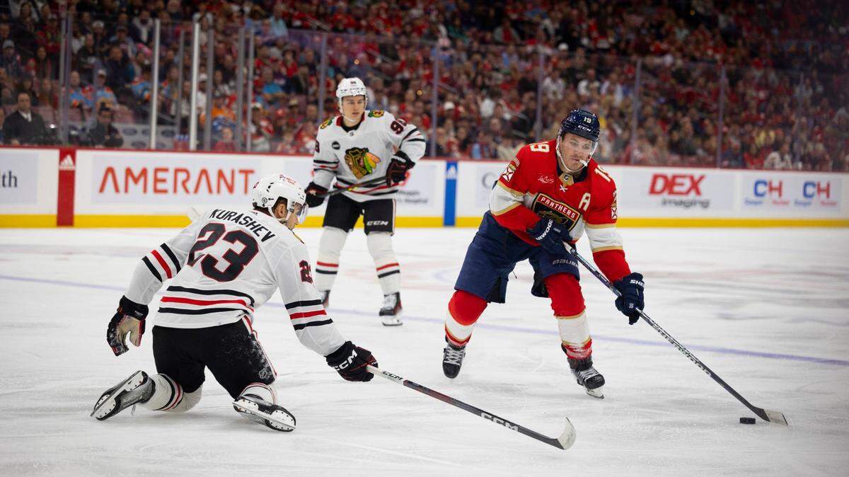 Florida Panthers left wing Matthew Tkachuk (19) looks for an opening as Chicago Blackhawks center Philipp Kurashev (23) defends during the second period of an NHL game at the Amerant Bank Arena on Sunday, Nov 12, 2023, in Sunrise, Fla.