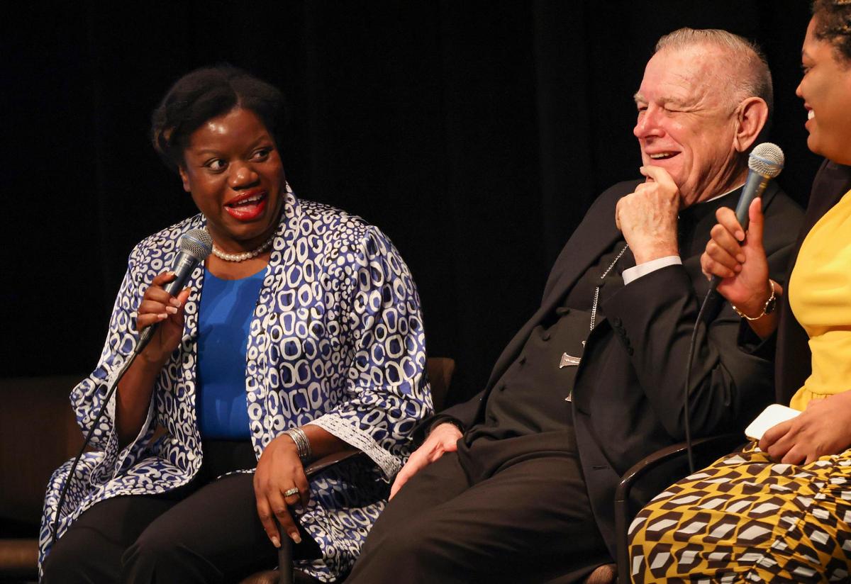 Guerline Jozef, left, founder and executive director of the Haitian Bridge Alliance that serves migrants at the U.S.-Mexico border, speaks during a panel about immigration on Thursday, Feb. 23, 2023, at Miami Dade College Wolfson Campus Auditorium.