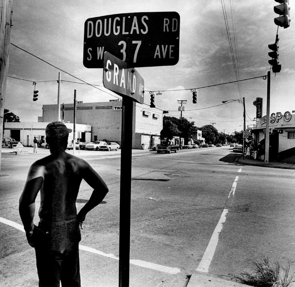A view of the four corners intersection at Douglas Road and Grand Avenue in the heyday of the historically Black western section of Miami’s Coconut Grove shows the Tikki Club just past the street sign at left and Gil’s Spot on the right.