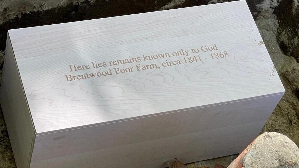 A local cabinet shop donated this wooden box for the remains. It was inscribed with, “Here lies remains known only to God, Brentwood Poor Farm, circa 1841 – 1868”.