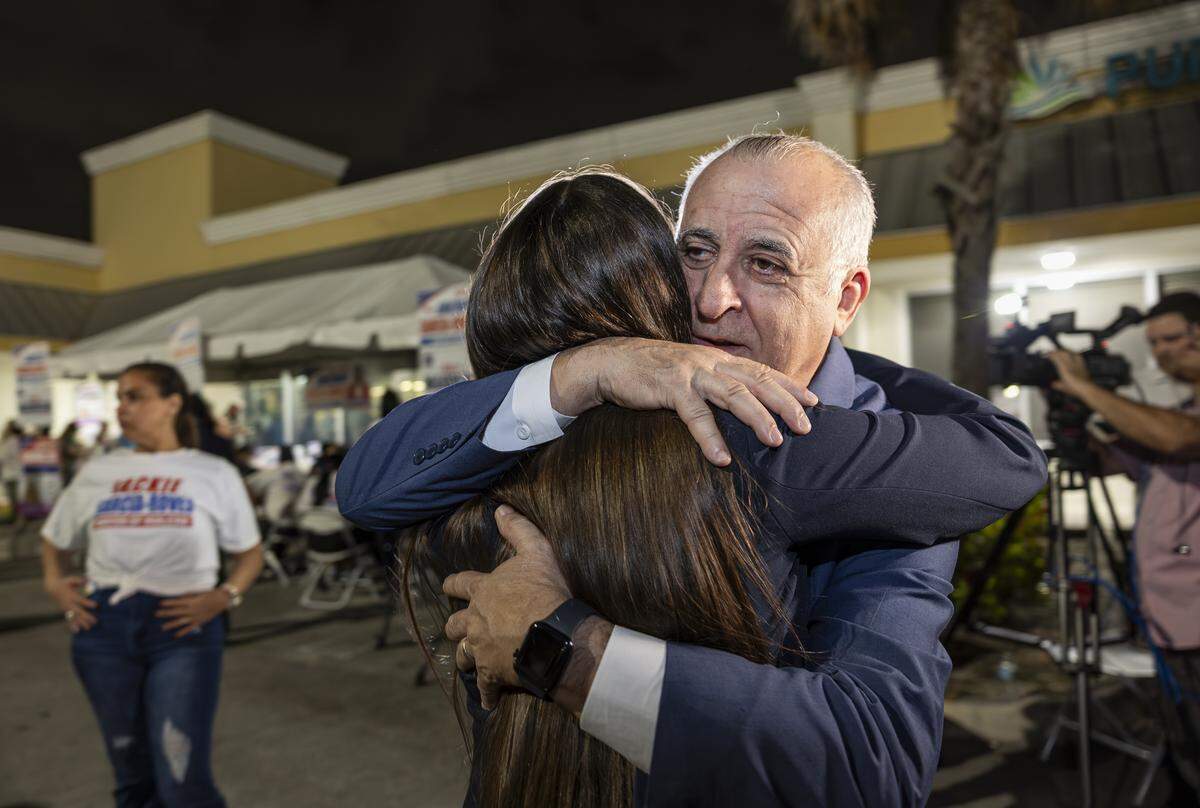 Interim Mayor Jackie Garcia-Roves is hugged by former Hialeah Mayor Esteban Bovo after losing the Hialeah mayoral race to Bryan Calvo on Tuesday, Nov. 4, 2025, in Hialeah, Fla.