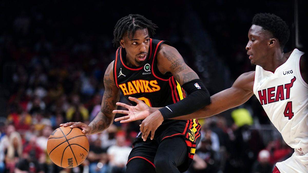 El escolta del Heat de Miami Victor Oldipo (der.) marca al jugador de los Hawks Delon Wright, en el cuarto partido de la serie de primera ronda de los playoffs celebrado el 24 de abril de 2022 en Atlanta.