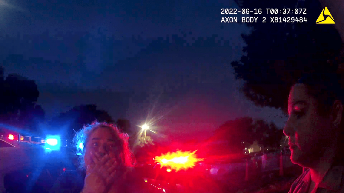 A shocked Gamaly Hollis, surrounded by officers in the Peppermill Apartments parking lot after Richard’s shooting. Image from Miami-Dade Police body camera.