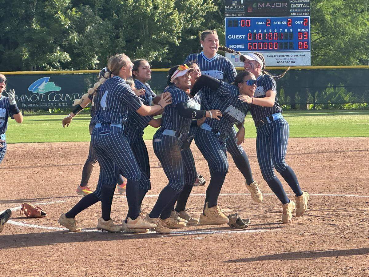 Coral Springs Charter softball players rush the pitching circle to celebrate after winning the Class 3A state championship on Friday at Boombah-Soldiers Creek Park in Longwood, Fla.
